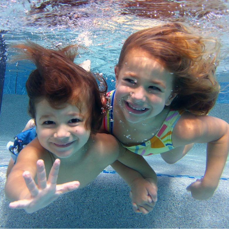 Happy Boy And Girl Under Water