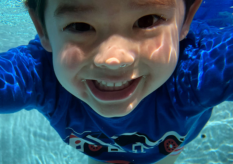 Happy Boy Smiling Under Water