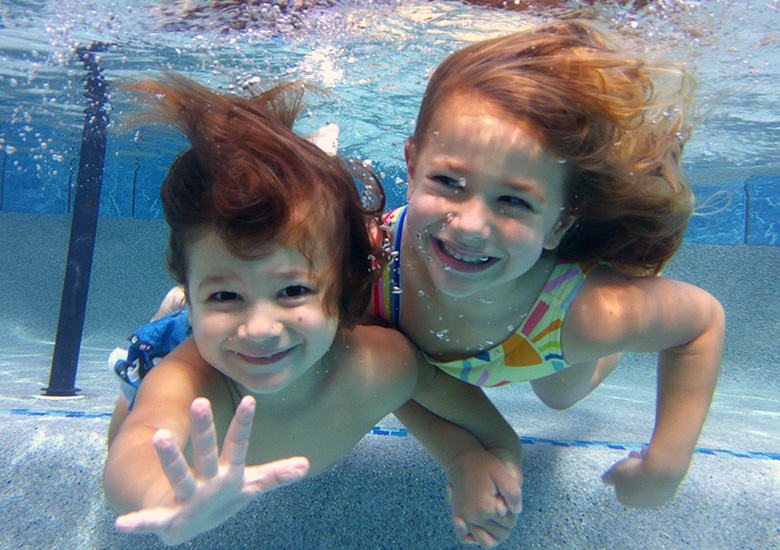 Happy Boy and Girl Under Water