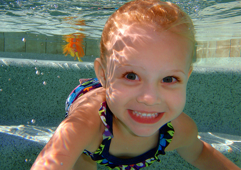 Happy Girl Smiling Under Water