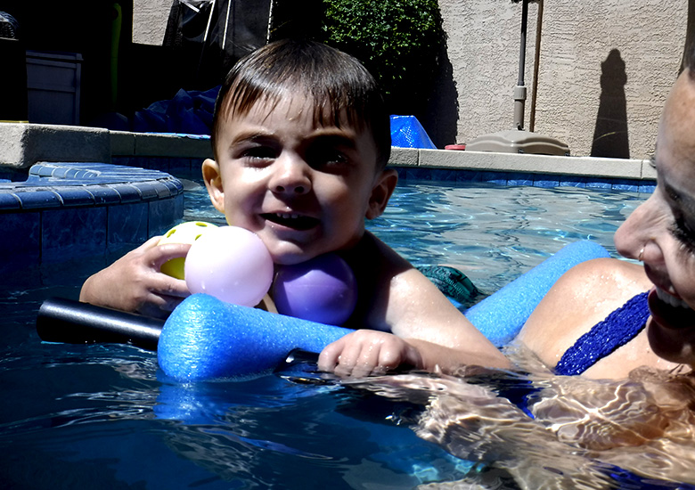 Little boy getting a swim lesson