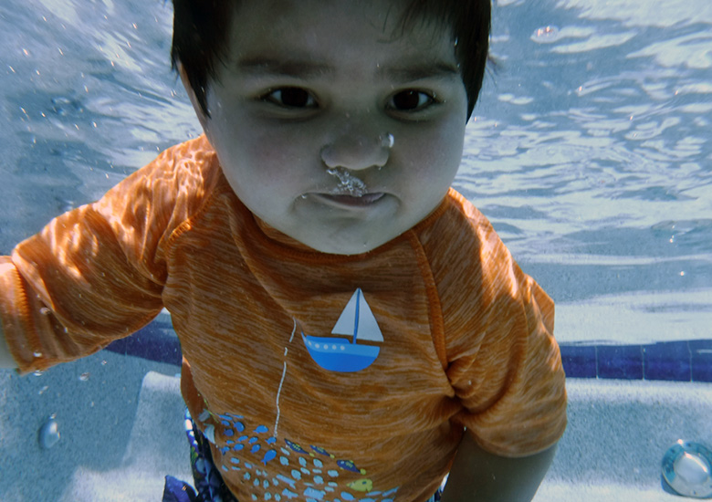 Toddler holding his breathe during a swim lesson